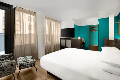 a bedroom with a white bed and a chair at Hyatt Centric Midtown 5th Avenue New York in New York