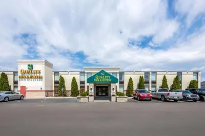 a building with cars parked in a parking lot at Quality Inn & Suites Mansfield in Mansfield