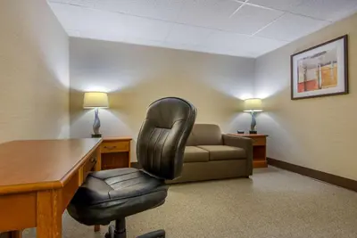 a office with a desk and a chair and a couch at Quality Inn & Suites Mansfield in Mansfield