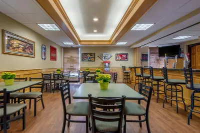 a restaurant with tables and chairs in a room at Quality Inn & Suites Mansfield in Mansfield