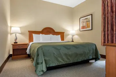 a hotel room with a bed and two lamps at Quality Inn & Suites Mansfield in Mansfield