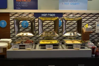 a buffet line with trays of food on display at Holiday Inn Express Selinsgrove by IHG in Shamokin Dam