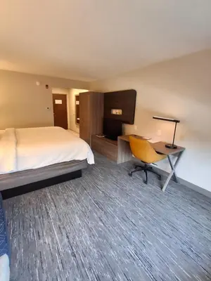 a hotel room with a bed and a desk and a chair at Holiday Inn Express Selinsgrove by IHG in Shamokin Dam