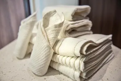 a pile of towels sitting on top of a table at Wyndham Garden North Bergen - Secaucus in North Bergen