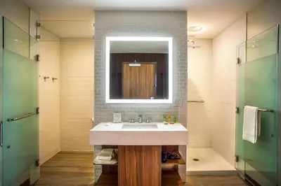 a bathroom with a sink and a mirror at Wyndham Garden North Bergen - Secaucus in North Bergen