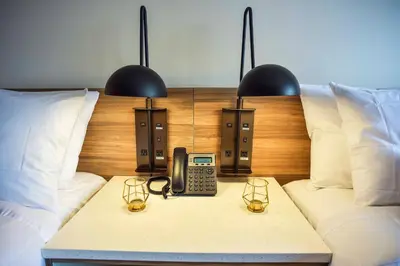 a room with a bed with a phone on a table at Wyndham Garden North Bergen - Secaucus in North Bergen