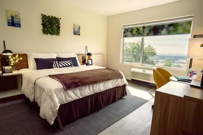 a bedroom with a large bed and a large window at Wyndham Garden North Bergen - Secaucus in North Bergen