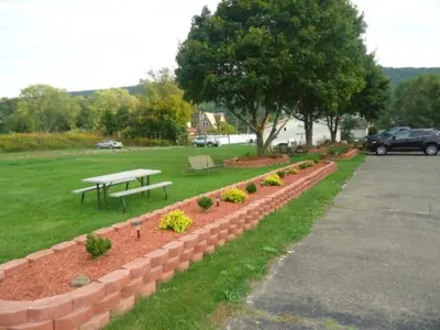 a park with a bench and a picnic table at Relax Inn in Fisherville