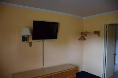 a flat screen tv on the wall of a room at Relax Inn in Fisherville