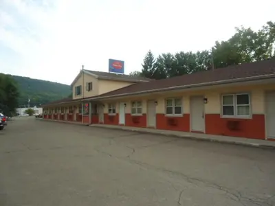 an empty parking lot in front of a motel at Relax Inn in Fisherville