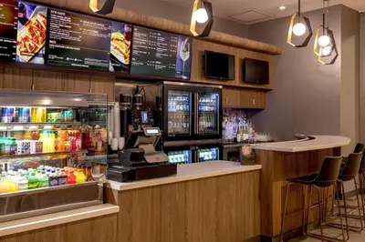 a fast food restaurant with a counter and a bar at Courtyard by Marriott Times Square West in New York