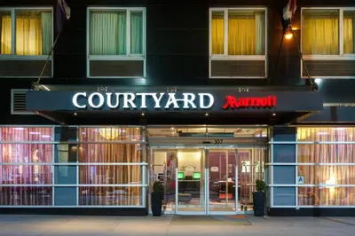 a store front of a court yard at night at Courtyard by Marriott Times Square West in New York
