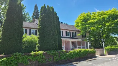 a house with trees in front of it at The Inn at Montchanin Village & Spa in Montchanin