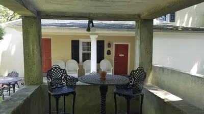a patio with a table and chairs on a porch at The Inn at Montchanin Village & Spa in Montchanin