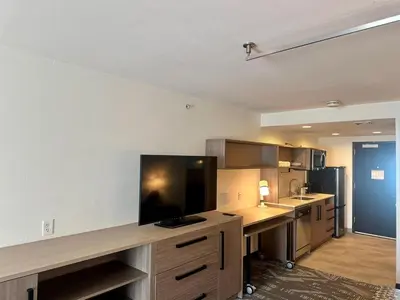 a large kitchen with a large tv on a counter at Home2 Suites by Hilton Rahway in Rahway
