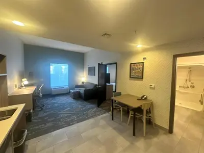 a living room with a table and a room with a couch at Home2 Suites by Hilton Rahway in Rahway