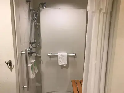 a bathroom with a toilet and a shower with a towel at Home2 Suites by Hilton Rahway in Rahway