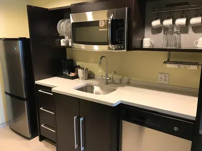 a kitchen with a sink and a microwave and a refrigerator at Home2 Suites by Hilton Rahway in Rahway