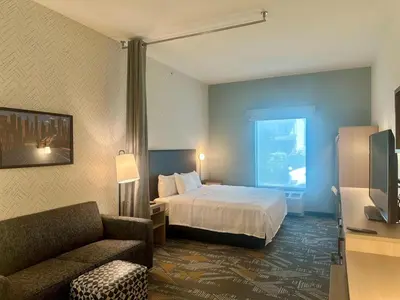 a hotel room with a bed and a couch at Home2 Suites by Hilton Rahway in Rahway