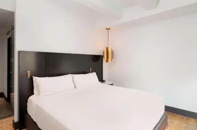 a bedroom with a white bed with a black headboard at Hyatt Union Square New York in New York