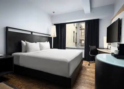 a hotel room with a white bed and a desk at Hyatt Union Square New York in New York