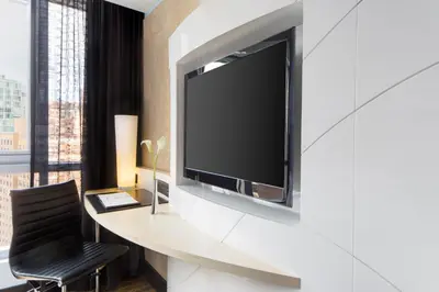 a living room with a television on a wall at Hyatt Union Square New York in New York