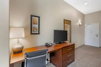 a room with a desk with a television and a lamp at Comfort Inn & Suites Gap Amish Country in Gap
