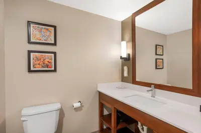 a bathroom with a sink and a mirror at Comfort Inn & Suites Gap Amish Country in Gap