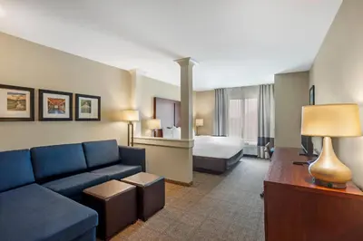a hotel room with a couch and a bed at Comfort Inn & Suites Gap Amish Country in Gap