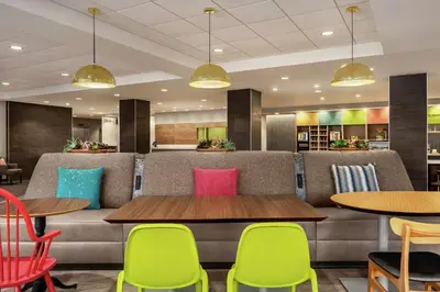 a dining room with colorful chairs and tables at Home2 Suites By Hilton Glen Mills Chadds Ford in Glen Mills