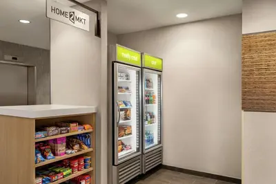 a refrigerator in a store with food in it at Home2 Suites By Hilton Glen Mills Chadds Ford in Glen Mills
