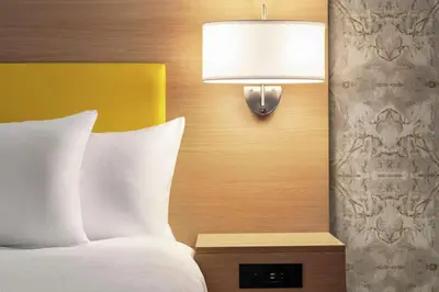 a bedroom with a bed and a lamp on the wall at Home2 Suites By Hilton Glen Mills Chadds Ford in Glen Mills