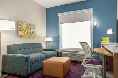 a living room with a couch and a table at Home2 Suites By Hilton Glen Mills Chadds Ford in Glen Mills
