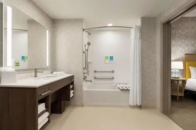 a bathroom with a tub and a sink and a shower at Home2 Suites By Hilton Glen Mills Chadds Ford in Glen Mills