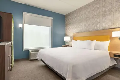 a bedroom with a large bed and a window at Home2 Suites By Hilton Glen Mills Chadds Ford in Glen Mills