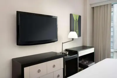 a bedroom with a flat screen tv on a wall at Best Western Premier Herald Square in New York