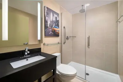 a bathroom with a sink and a toilet and a shower at Best Western Premier Herald Square in New York