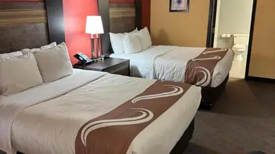 a hotel room with two beds and a lamp at Appalachian Hotel in Carlisle