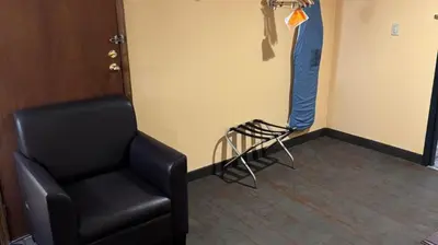 a room with a chair in a room with a door at Appalachian Hotel in Carlisle