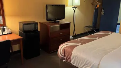 a hotel room with a bed and a television at Appalachian Hotel in Carlisle