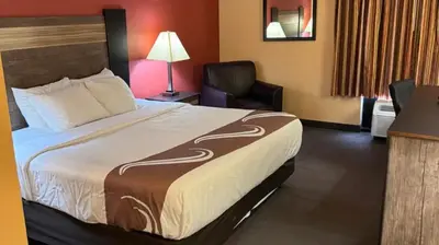 a hotel room with a bed and a chair at Appalachian Hotel in Carlisle