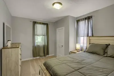 a bedroom with a large bed and a window at Stay On State - 15 Min to Harrisburg, 30 Min to Carlisle 2BR tastefully decorated in Duncannon