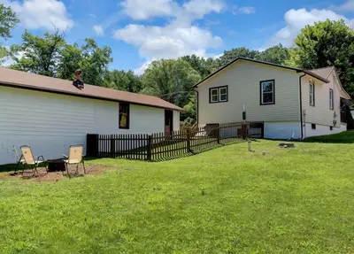 a white house with two chairs in a yard at Stay On State - 15 Min to Harrisburg, 30 Min to Carlisle 2BR tastefully decorated in Duncannon