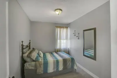 a bedroom with a bed and a mirror at Stay On State - 15 Min to Harrisburg, 30 Min to Carlisle 2BR tastefully decorated in Duncannon