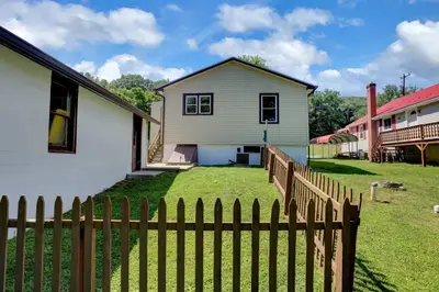 a white house with a fence in front of it at Stay On State - 15 Min to Harrisburg, 30 Min to Carlisle 2BR tastefully decorated in Duncannon