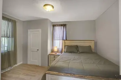a bedroom with a bed and a desk and a window at Stay On State - 15 Min to Harrisburg, 30 Min to Carlisle 2BR tastefully decorated in Duncannon