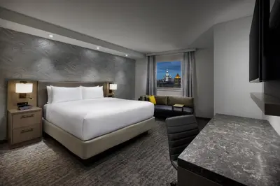 a hotel room with a large white bed and a couch at Residence Inn New York Downtown Manhattan/Financial District in New York