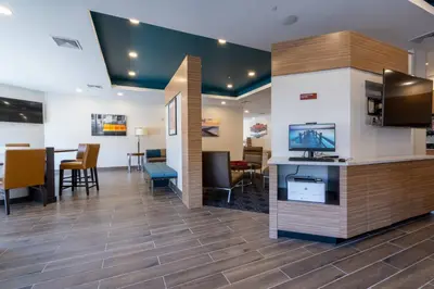 a lobby with a waiting area with a tv and a table at TownePlace Suites by Marriott Clinton in Clinton