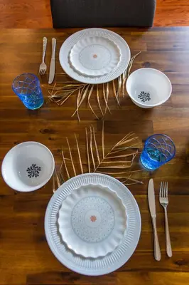 a table with plates and utensils on a wooden table at Sleeps 4! 2BR, Gym, Paid Parking, Close to Major Attractions in Philadelphia