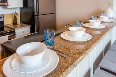 a kitchen with four bowls and plates on a counter at Sleeps 4! 2BR, Gym, Paid Parking, Close to Major Attractions in Philadelphia